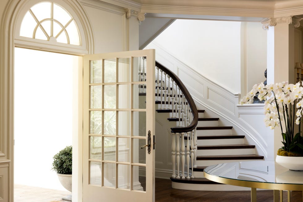 Interior of a home with a staircase and an open door. Interior of a home with a staircase and an open door.