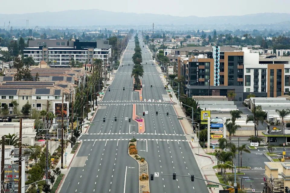 An eight lane highway devoid of any traffic in California, seen from the air. (Ethan Swope / AP)