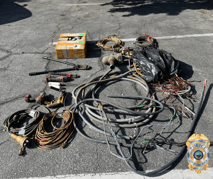 Recovered copper wiring, brass, tools and burglary equipment seized by Long Beach police during a copper theft investigation in May 2026.