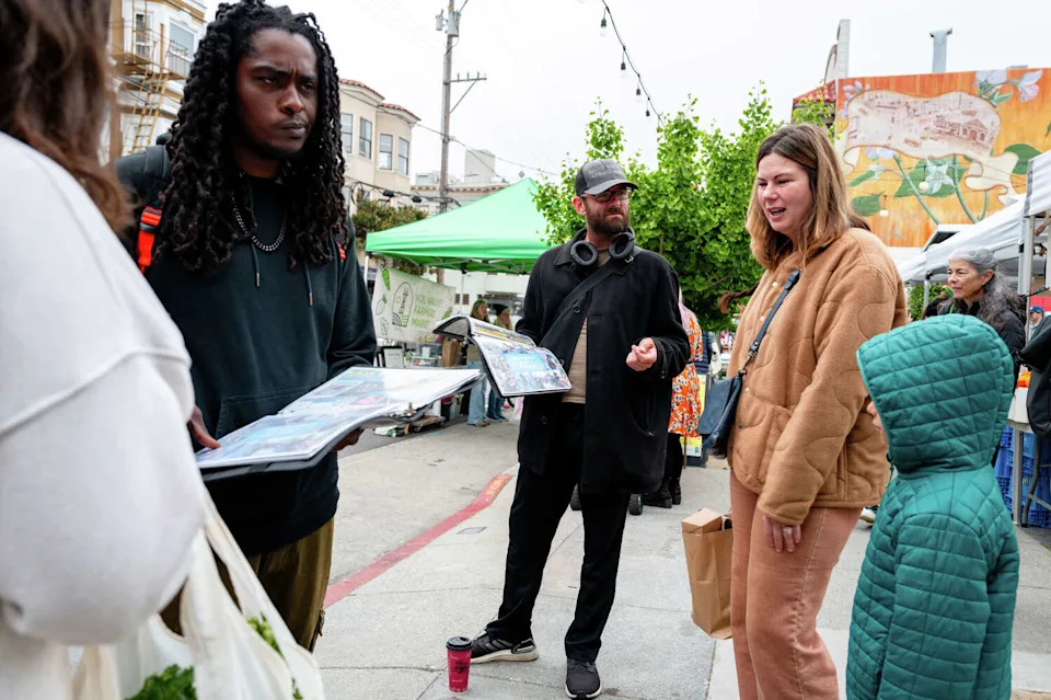 Two men solicit signatures for upcoming ballot measures outside the Noe Valley Farmer's Market in San Francisco on May 2. (Adam Pardee/For the S.F. Chronicle)