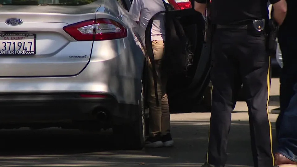 <div>A child enters a car at the scene on Lancelot Lane in San Jose. May 13, 2026.</div>