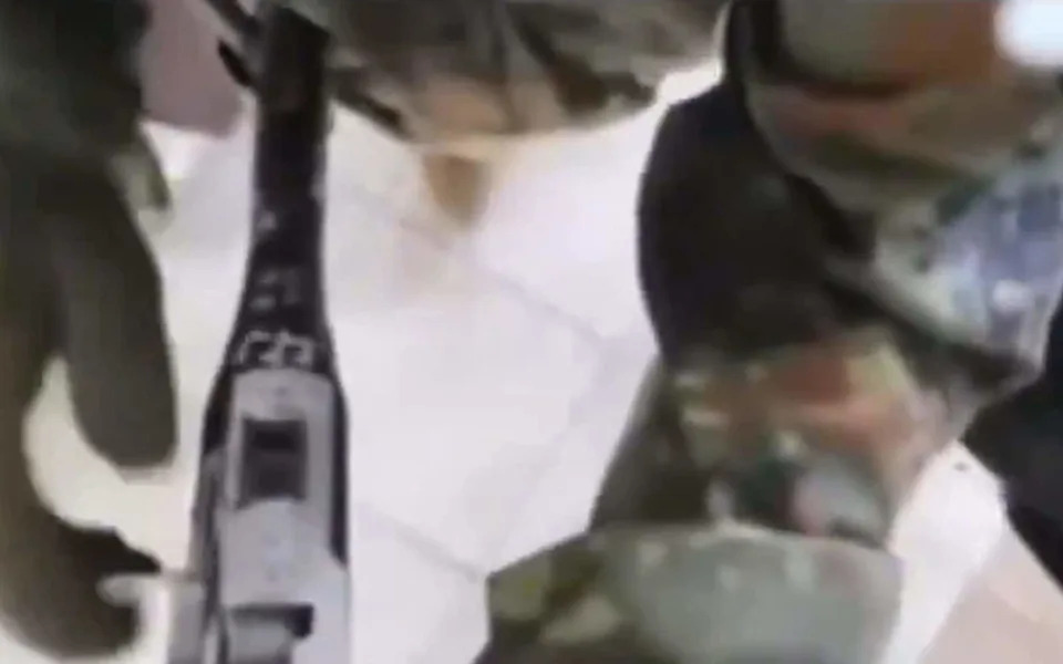 An image from a livestreamed video that depicts the San Diego mosque shooters carrying out their attack