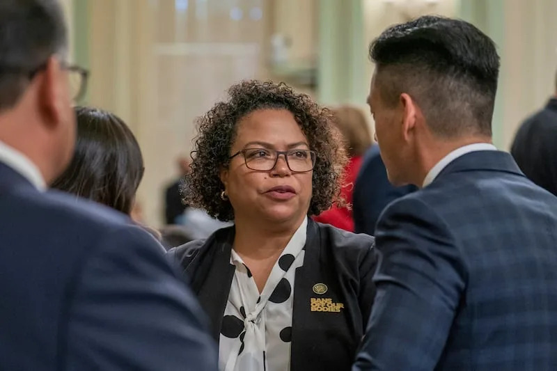 Assembly member Mia Bonta, D-Oakland, center, talks with Assembly member Evan Low, D-Silicon Valley, right, at the Capitol in Sacramento, Calif., Thursday, June 1, 2023. | Rich Pedroncelli, Associated Press