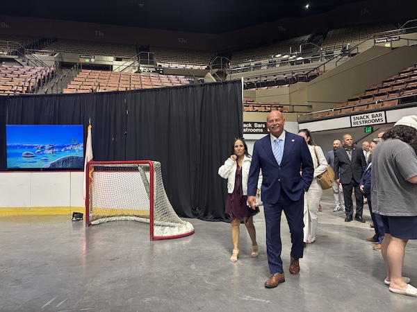 man walks on the floor of an arena
