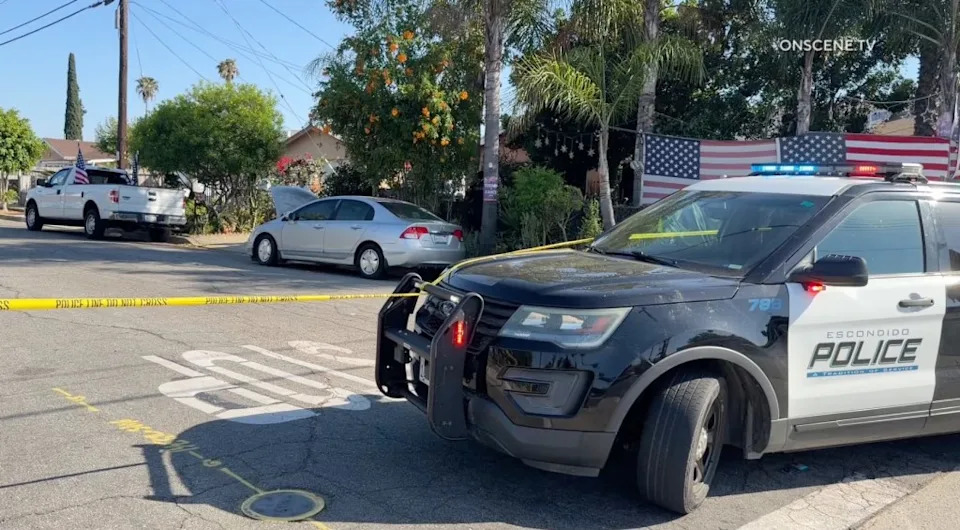 An Escondido Police vehicle with flashing lights and crime scene tape. onscene.tv