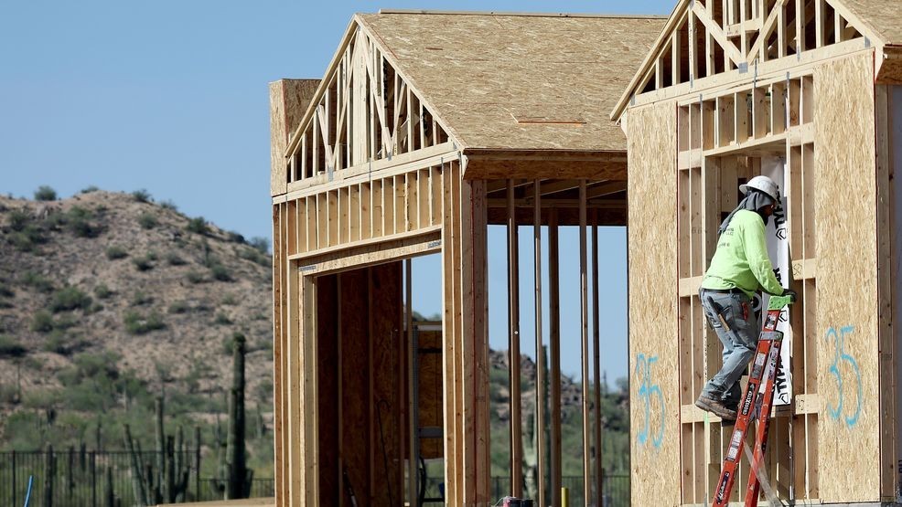 FILE - A worker helps construct a new home June 8, 2023, in Buckeye, Arizona. (Photo by Mario Tama/Getty Images)