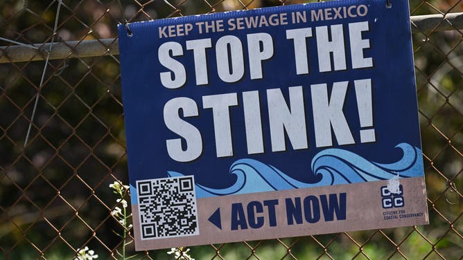 A sign reads "Stop The Stink" near the Tijuana River Valley area by Border Field State Park along the US-Mexico border between San Diego and Tijuana in San Diego County, California, on April 23, 2025. In recent years, the US-Mexico border sewage pollution problem has closed beaches and raised concerns over public health issues.