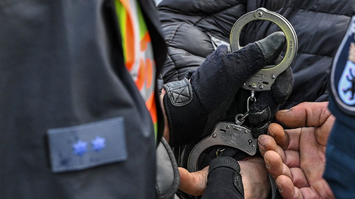 man's hands getting handcuffed