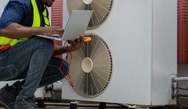 A technician in a safety vest uses a laptop to inspect a heat pump with visible electrical tools.