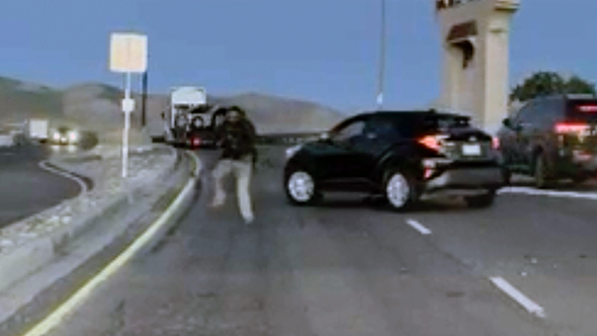 Shooting incident occurring on a busy road with vehicles present