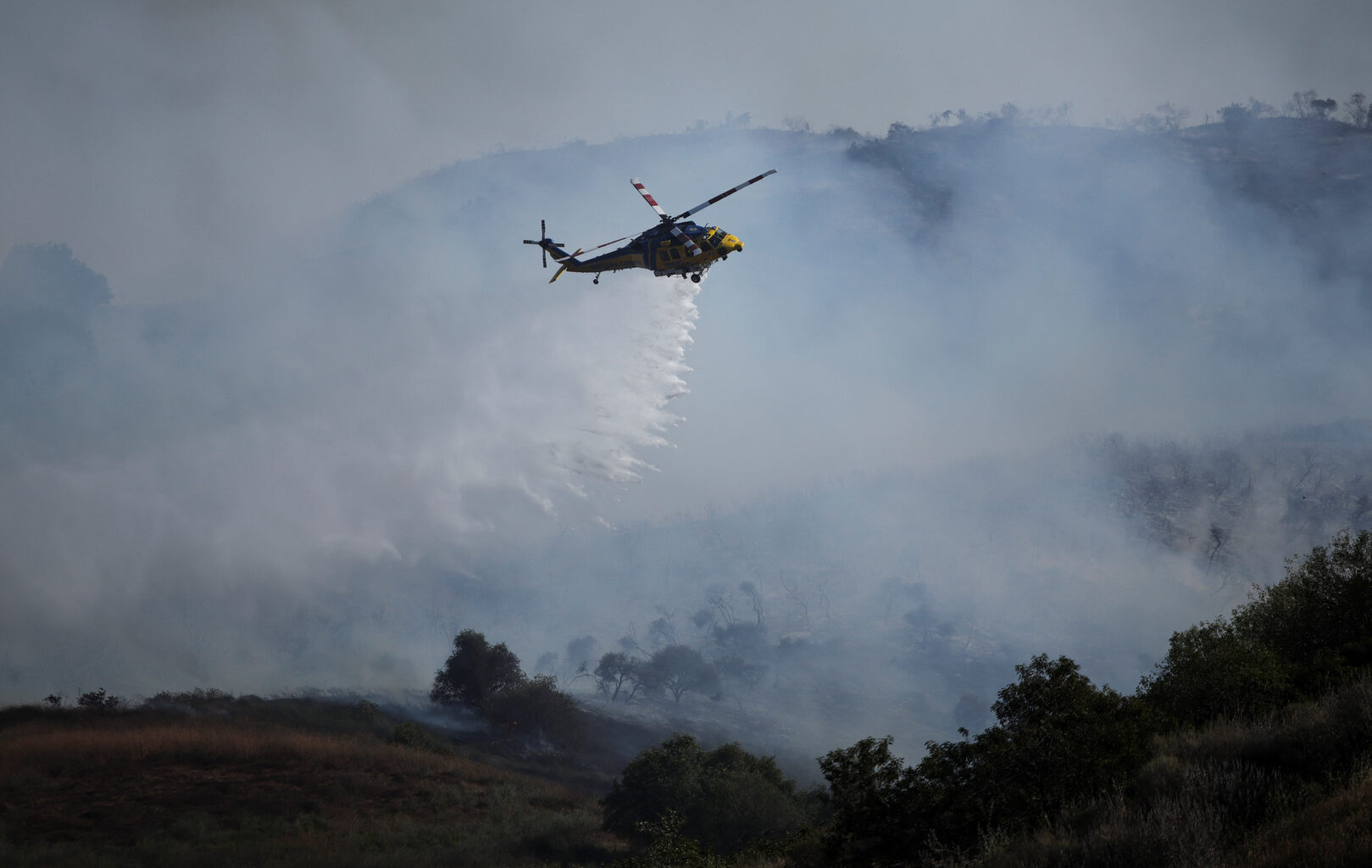 Helicopters douse flames threatening hillside homes in California | Newsfeed