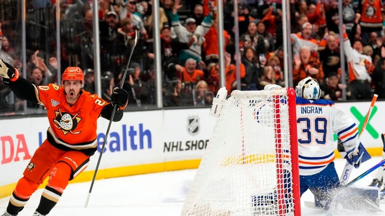 Anaheim Ducks left wing Chris Kreider, left, celebrates his goal...