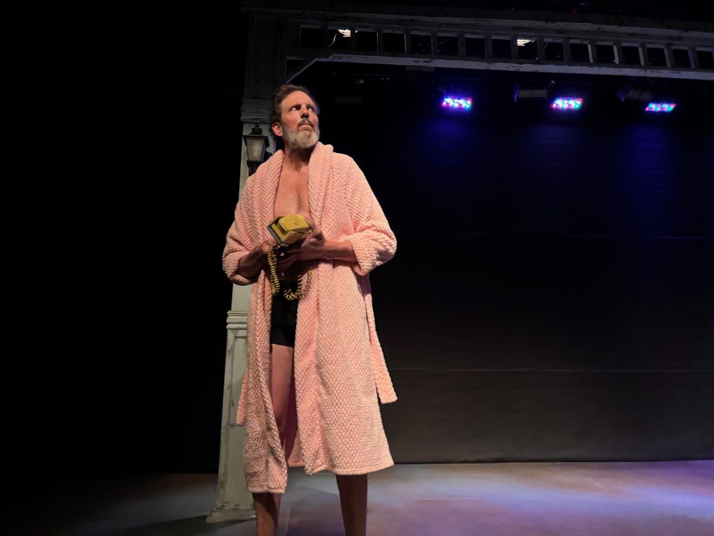 This Ends Badly short plays actor in robe holding phone on stage dramatic moment Echo Theater