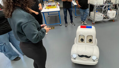 college age female operating a remote controlled miniature police car