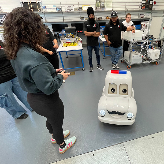 college age female operating a remote controlled miniature police car