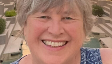 adult female with gray hair smiling