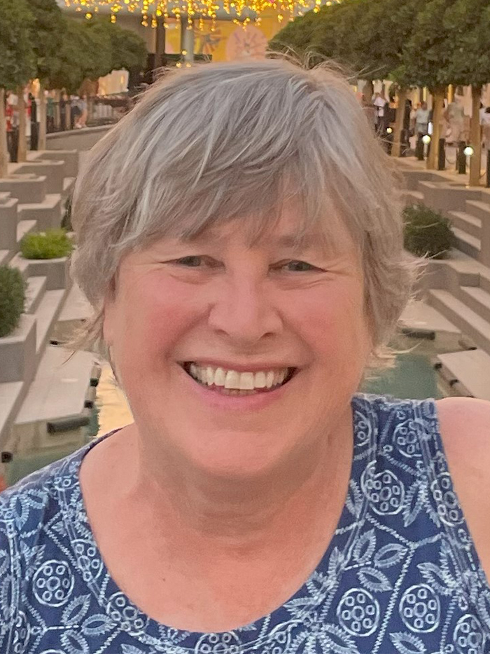 adult female with gray hair smiling