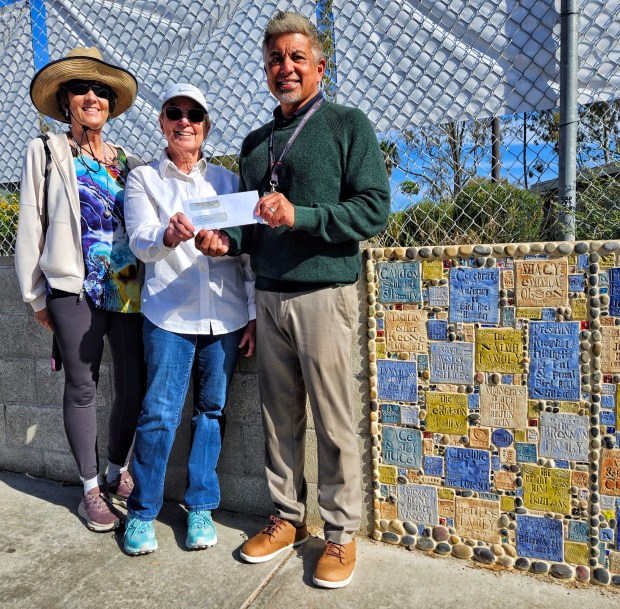 Artist Jane Wheeler, Bird Rock Community Council board member Barbara Dunbar and Bird Rock Elementary School Principal Eric Banatao stand next to a new section of the school's Waverly Gate Community Wall. (Pearl Preis)