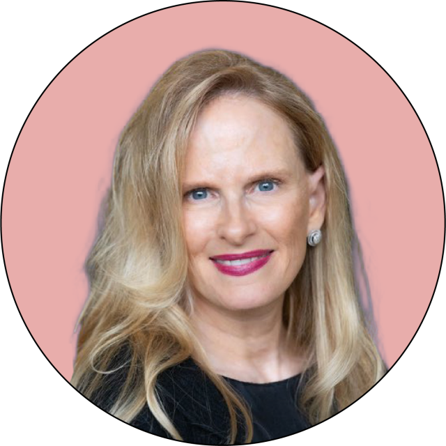 A woman with long blonde hair, wearing a black top and silver earrings, smiles at the camera against a pink background.