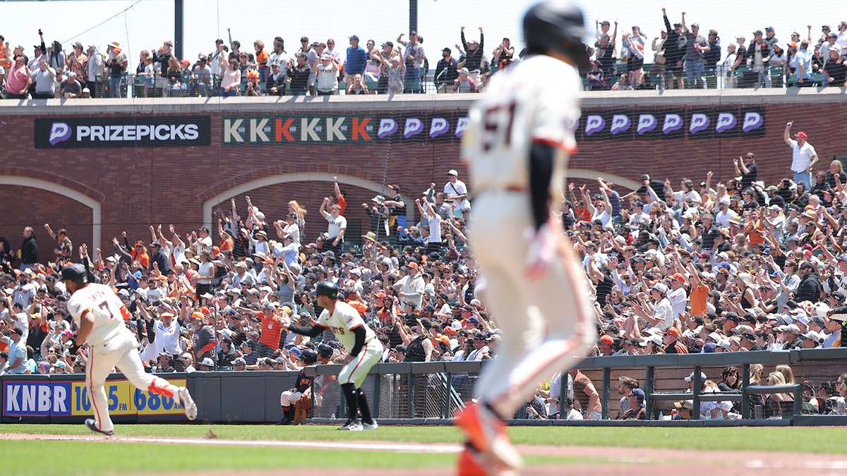 Dominic Smith rounding first base during a baseball game at Oracle Park