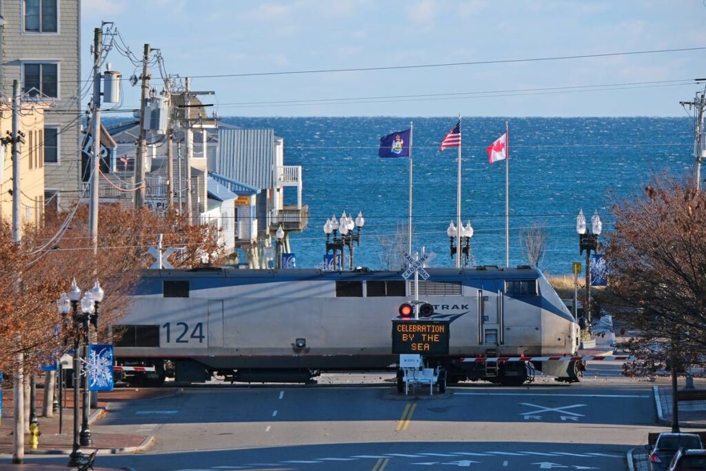 OLD ORCHARD BEACH, UNITED STATES - A closeup of the passenger train with the Atlantic Ocean behind
