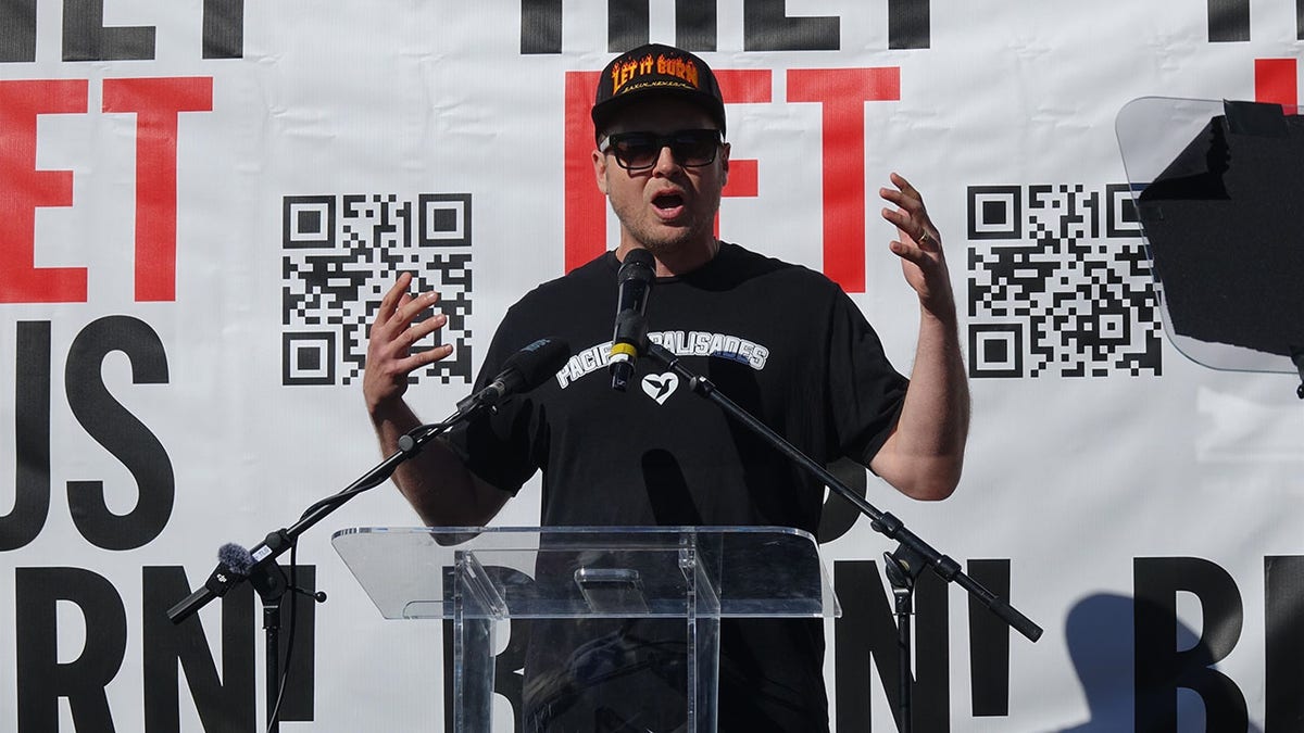 Spencer Pratt speaking onstage at a rally in Pacific Palisades