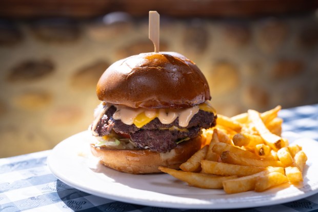 From the Hamburger Factory in Poway, CA., the Smashburger, cooked two 1/4 lb patties smashed and seared. America cheese, pickles, lettuce, tomato, and awesome sauce. (Nelvin C. Cepeda The San Diego Union-Tribune)