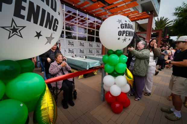 Co-owner Margarita Hernandez of Las Cuatro Milpas becomes emotional at the start of the reopening of Las Cuatros Milpas in Barrio Logan.  (Nelvin C. Cepeda / The San Diego Union-Tribune)