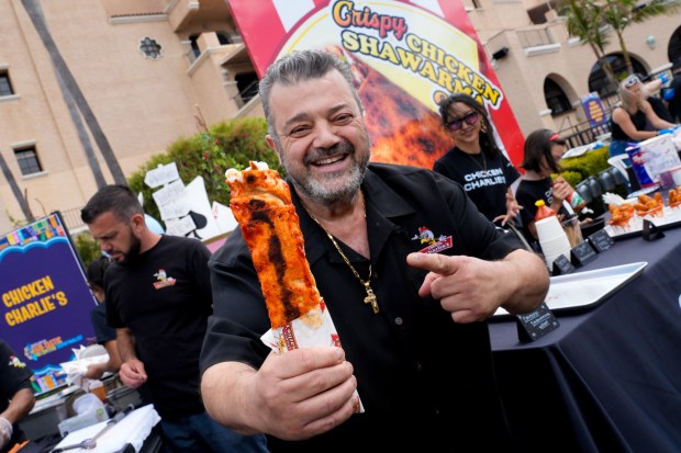 Charlie Boghosian of the popular Chicken Charlie's shows off his latest food item for this year's 2026 San Diego County Fair, the Chicken Shawarma. (Nelvin C. Cepeda / The San Diego Union-Tribune)