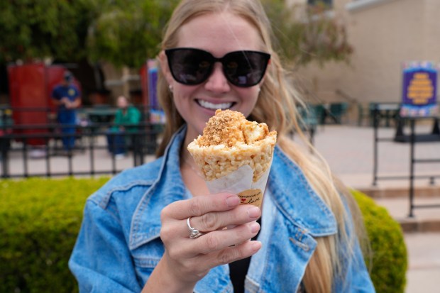 Kayla Taggart shows off the new cinnamon crunch cheesecake rice crispy cone that will be added for this year's 2026 San Diego County Fair. (Nelvin C. Cepeda / The San Diego Union-Tribune)