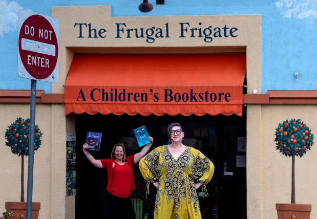 Erin Rivera, right, outside the Frugal Frigate, her children's bookstore in Redlands.(SCNG)
