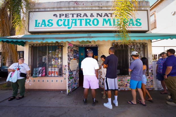 A steady lunch crowd line forms at Las Cuatro Milpas in Barrio Logan, which is expected to close by the end of this year.