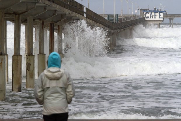 A woman watches as large surf rolls to the beach past the Ocean Beach Pier which was closed because of the high surf after strong storms in San Diego, California on January 7, 2016. The first major El Nino storm of the season battered southern California this week, bringing heavy rain to the drought-stricken region and causing flooding and mudslides in some areas. Several El Nino storms are expected to hit California in the coming weeks, but experts warn that the rainfall will not be enough to help the region recover from a historic drought. AFP PHOTO/ BILL WECHTERBill Wechter/AFP/Getty Images ** OUTS - ELSENT, FPG, CM - OUTS * NM, PH, VA if sourced by CT, LA or MoD **
