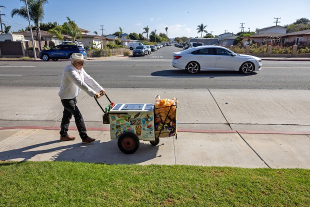 Francisco Duarte, a paletero, sells ice cream, popsicles and other snacks in the Nestor neighborhood on Oct. 8. (Ana Ramirez / U-T file)
