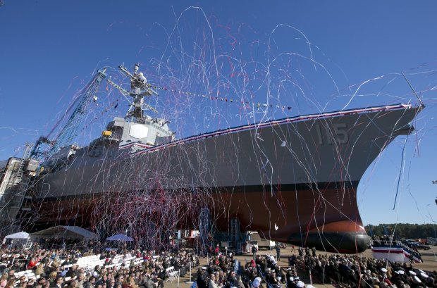 CORRECTS FROM RAPHAEL TO RAFAEL- Streamers fly during the christening the USS Rafael Peralta, the 35th Arleigh Burke Class Missile Destroyer to be built by Bath Iron Works, Saturday, Oct. 31, 2015, in Bath, Maine. The warship is named for Sgt. Rafael Peralta who was killed in action on Nov. 15, 2004 while clearing houses in the city of Fallujah, Iraq, during Operation Al Fajr.(AP Photo/Robert F. Bukaty)