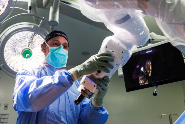 An X-ray is taken of a patient's spine before a spinal fusion surgery at Jacobs Medical Center at UC San Diego Health in La Jolla on Wednesday, April 29, 2026. (Kristian Carreon / The San Diego Union-Tribune)Dr. Joseph Osorio, a neurosurgeon, uses the Medtronic Stealth Axis Autopilot during a spinal fusion surgery at Jacobs Medical Center at UC San Diego Health in La Jolla on Wednesday, April 29, 2026. The machine uses artificial intelligence to help navigate a patient's spine.(Kristian Carreon / The San Diego Union-Tribune)