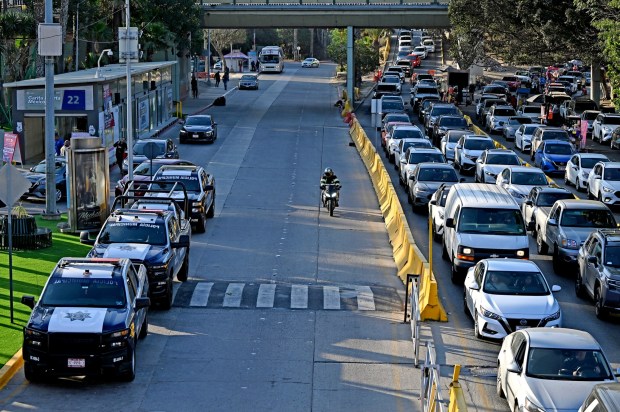 Police vehicles at the San Ysidro Port of Entry near the SENTRI care lane in Tijuana, Mexico on Tuesday, April 07, 2026. Some visitors who come from the US with California license plates have been given traffic tickets by police trying to extort them for money, in response Tijuana officials have created a phone app for claims of extortion by corrupt cops. (Carlos Moreno / The San Diego Union-Tribune)