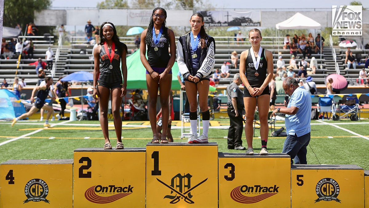 Transgender student athlete AB Hernandez posing with other track and field finishers