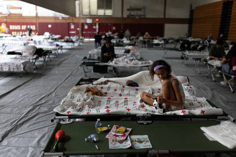 ED OU / REUTERS
                                Minnie Ellis, 10, who evacuated from Garden Grove, Calif., sits today on a cot at Ocean View High School Gymnasium in Huntington Beach, which has been turned into a temporary shelter after residents were evacuated in response to a failing tank containing methyl methacrylate, a flammable liquid used in the aerospace industry.