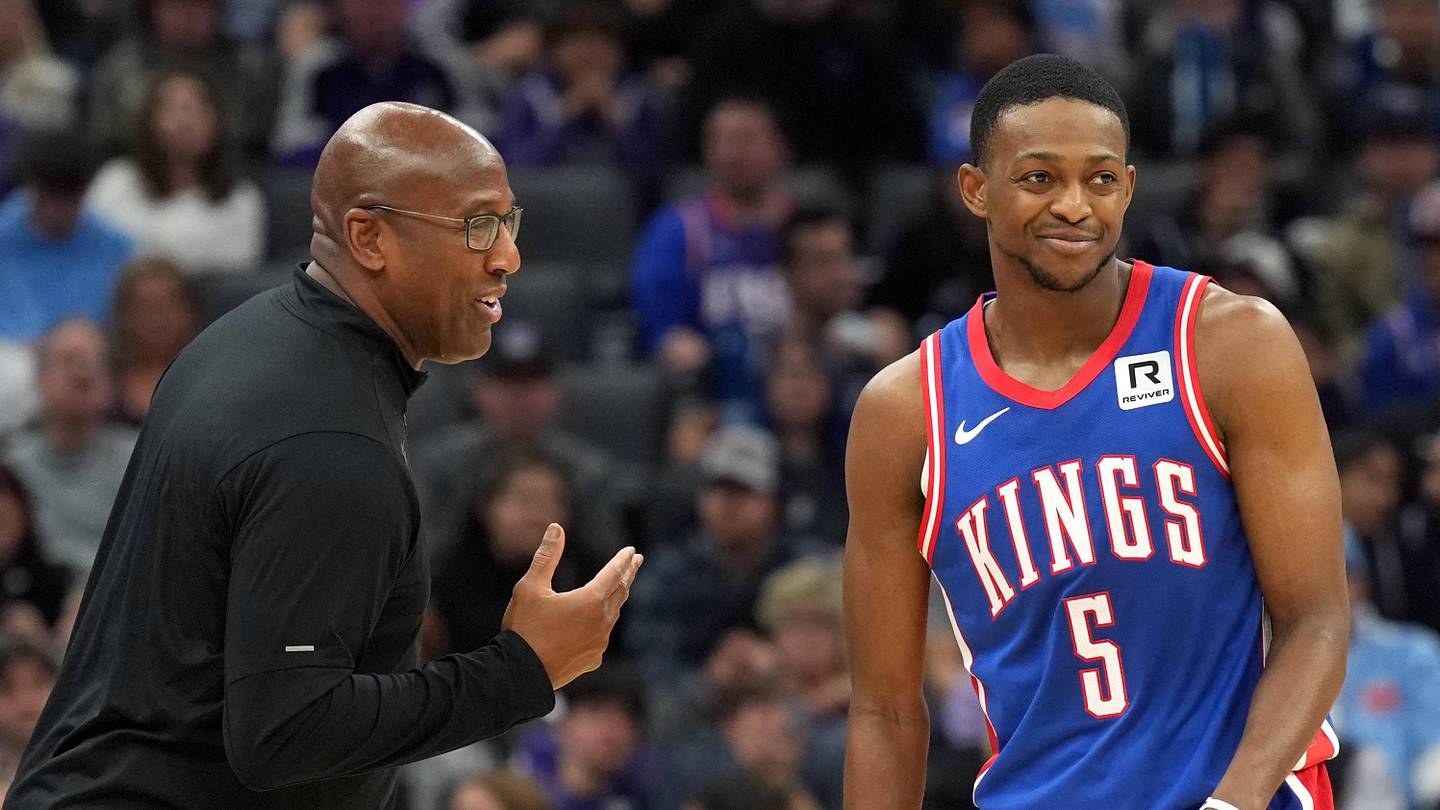Nov 16, 2024; Sacramento, California, USA; Sacramento Kings head coach Mike Brown (left) talks with guard De'Aaron Fox (5) during the second quarter against the Utah Jazz at Golden 1 Center. Mandatory Credit: Darren Yamashita-Imagn Images