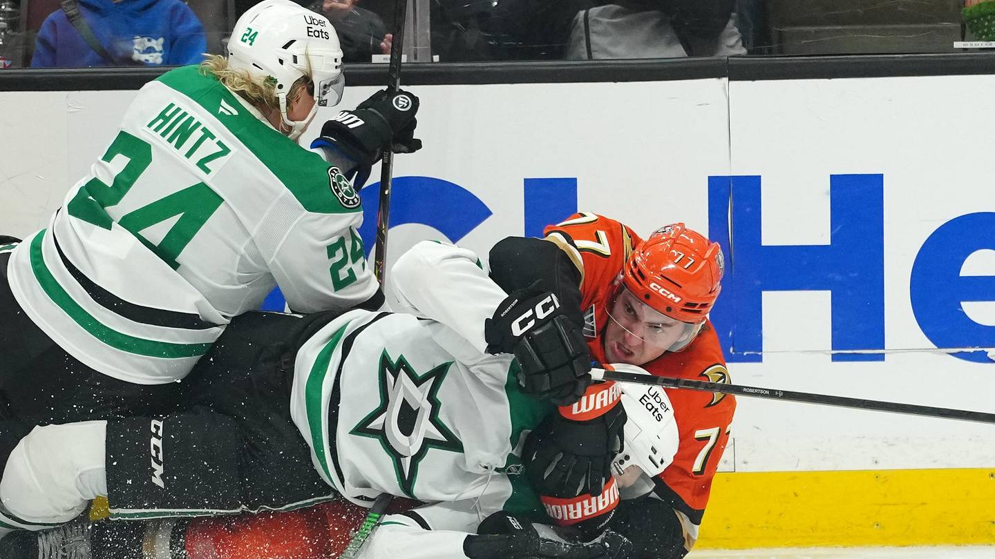 Dec 19, 2025; Anaheim, California, USA; Anaheim Ducks right wing Frank Vatrano (77) grapples with Dallas Stars left wing Jason Robertson (21) and center Roope Hintz (24) in the third period at Honda Center. Mandatory Credit: Kirby Lee-Imagn Images
