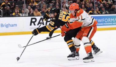 Oct 23, 2025; Boston, Massachusetts, USA; Boston Bruins center Sean Kuraly (52) shoots the puck while Anaheim Ducks defenseman Olen Zellweger (51) defends during the first period at TD Garden. Mandatory Credit: Bob DeChiara-Imagn Images