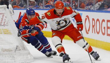 Apr 28, 2026; Edmonton, Alberta, CAN; Anaheim Ducks defensemen John Carlson (74) protects the puck from Edmonton Oilers forward Zach Hyman (18) during the third period in game five of the first round of the 2026 Stanley Cup Playoffs at Rogers Place. Mandatory Credit: Perry Nelson-Imagn Images