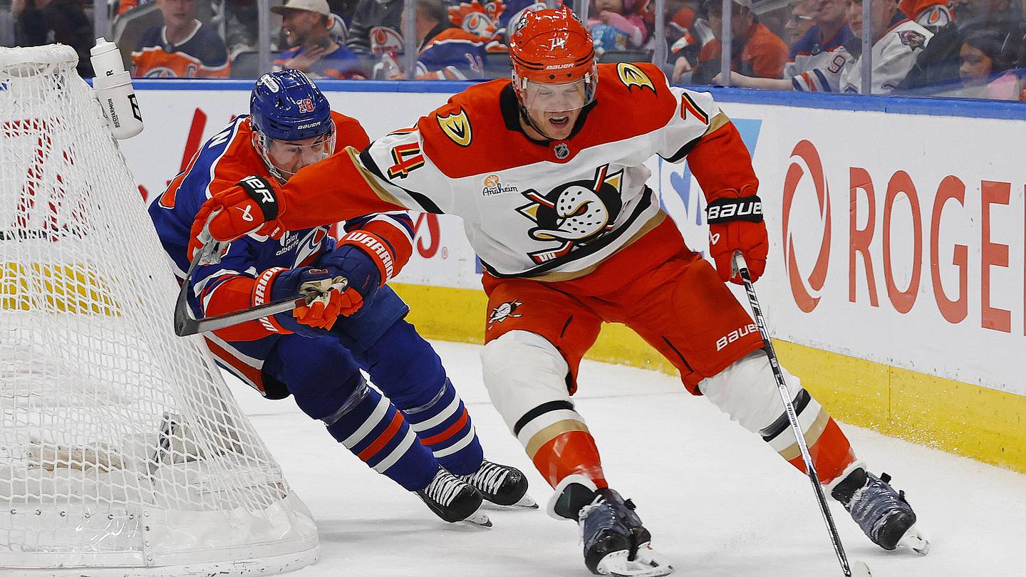 Apr 28, 2026; Edmonton, Alberta, CAN; Anaheim Ducks defensemen John Carlson (74) protects the puck from Edmonton Oilers forward Zach Hyman (18) during the third period in game five of the first round of the 2026 Stanley Cup Playoffs at Rogers Place. Mandatory Credit: Perry Nelson-Imagn Images