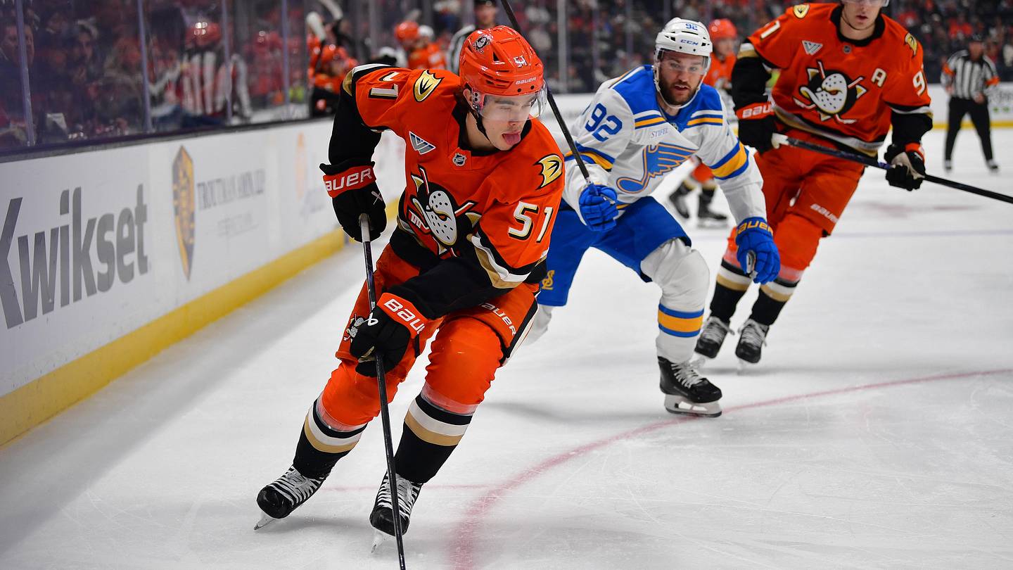 Apr 3, 2026; Anaheim, California, USA; Anaheim Ducks defenseman Olen Zellweger (51) moves the puck against St. Louis Blues left wing Jonathan Drouin (92) during the first period at Honda Center. Mandatory Credit: Gary A. Vasquez-Imagn Images