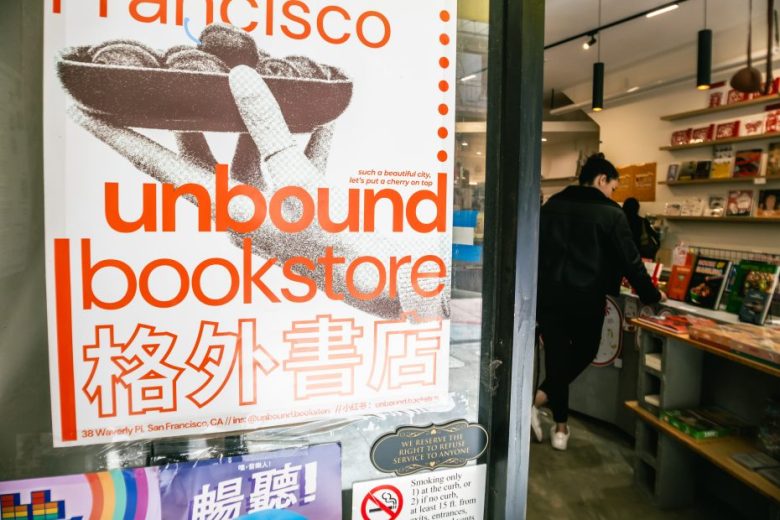 Poster for "unbound bookstore" with English and Chinese text displayed on a glass door, while a person browses books inside the store.