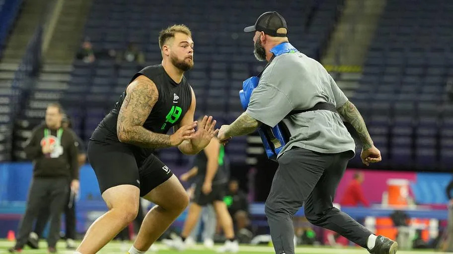 Boston College offensive lineman Logan Taylor with Chargers assistant offensive line coach Nick Hardwick.