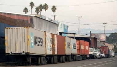 Shipping containers on trailers lined up on a West Oakland street.