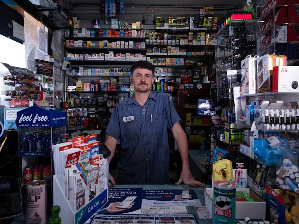 A store clerk named Cody stands behind a counter in a convenience store. Andy Johnstone for CA Post