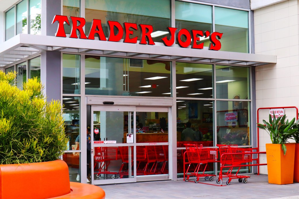 Exterior of a Trader Joe's grocery store with red shopping carts outside the entrance.
